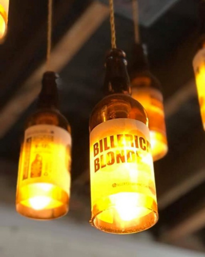 Closeup of the beer bottle lights that hang from the ceiling of the Micropub